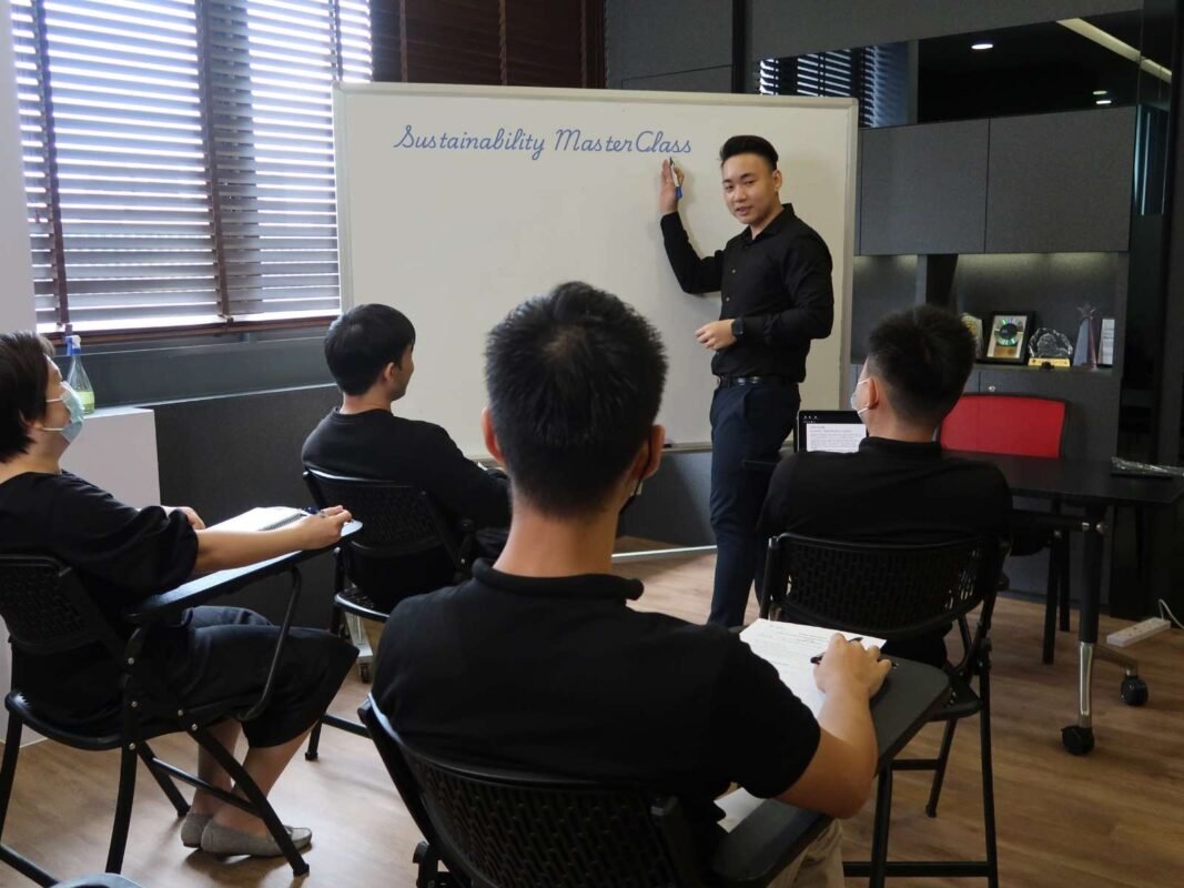 Trainer conducting a sustainability masterclass, educating participants on eco-friendly practices and sustainable development.
