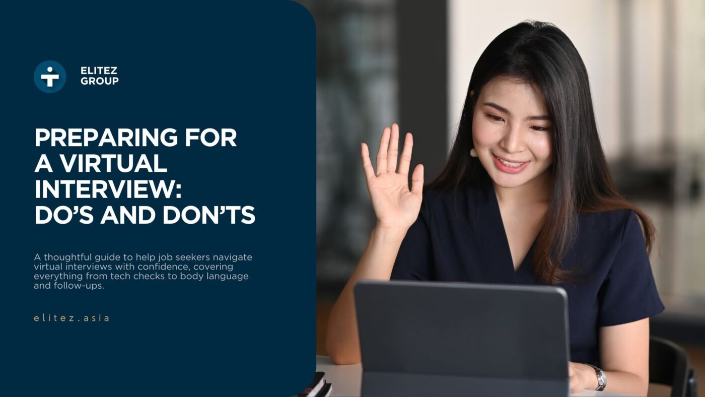 Woman having a virtual interview, smiling and waving at her laptop screen