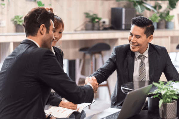 A boss shakes hands with an employee