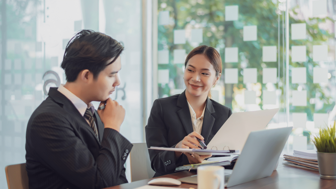Hiring manager and recruitment consultant reviewing resumes for strategic permanent roles in Singapore