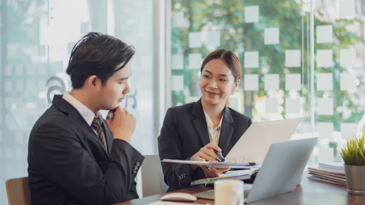 Hiring manager and recruitment consultant reviewing resumes for strategic permanent roles in Singapore
