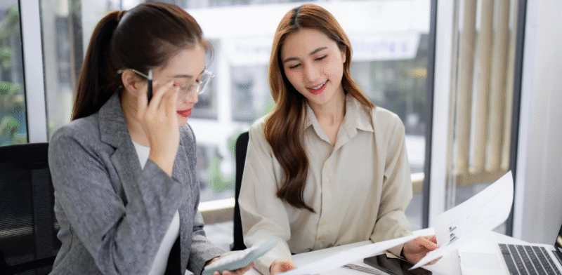 Recruitment consultants reviewing candidate profiles during a hiring discussion