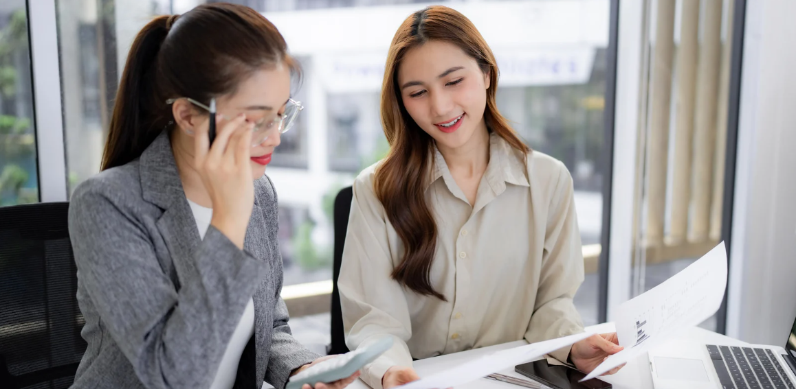 Recruitment consultants reviewing candidate profiles during a hiring discussion