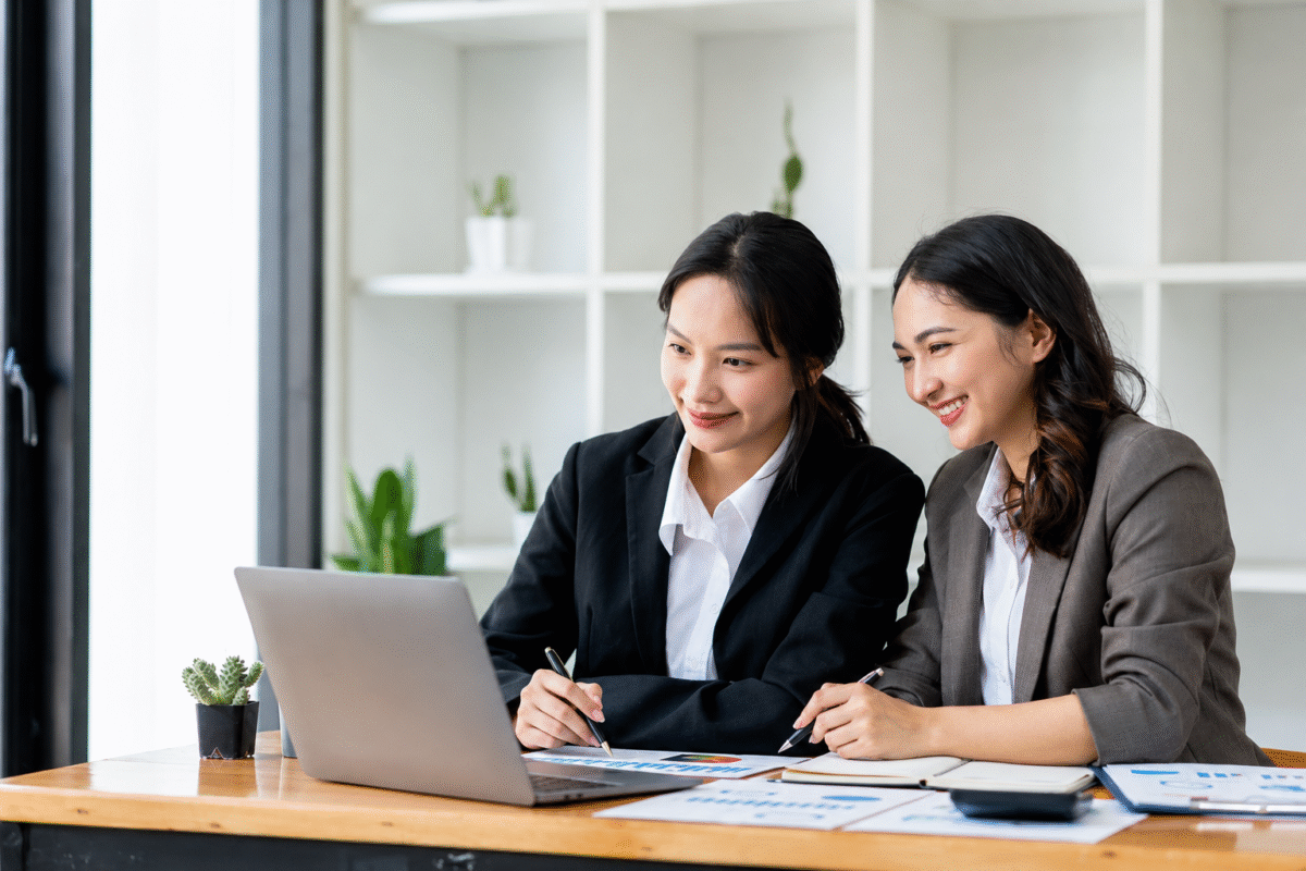 The vietnam team is reviewing workforce reports on a laptop, representing workforce readiness and strategic planning in Vietnam’s growing economy.